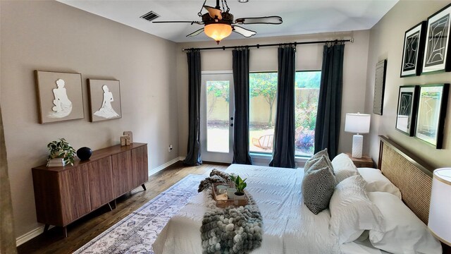 bedroom featuring baseboards, wood finished floors, and ceiling fan