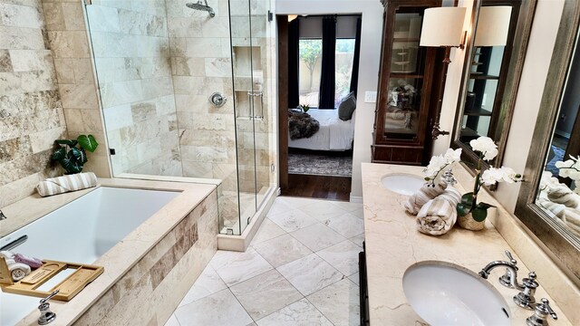 bathroom featuring a stall shower, ensuite bath, a garden tub, and vanity