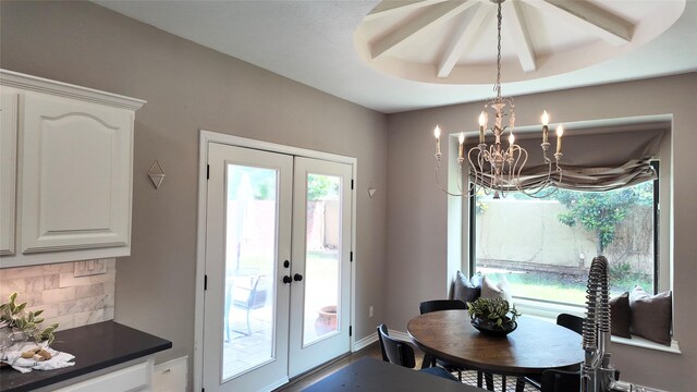 dining area featuring french doors, a chandelier, baseboards, and dark wood-style flooring