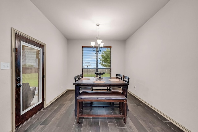 dining room with a chandelier, wood finished floors, and baseboards