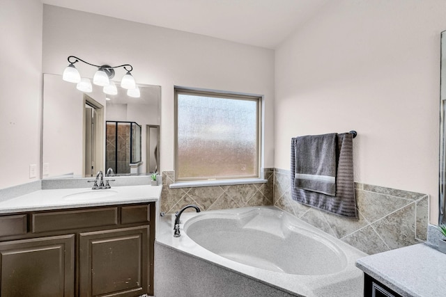 full bath with vanity and a bath