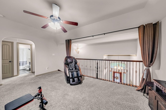 living area with a ceiling fan, a chandelier, carpet floors, arched walkways, and baseboards