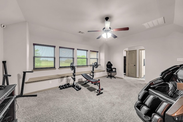 workout room with lofted ceiling, arched walkways, carpet, ceiling fan, and baseboards
