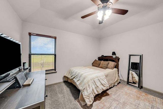 bedroom with light colored carpet, baseboards, ceiling fan, and a desk