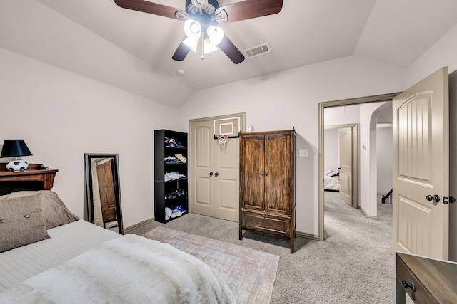 bedroom with lofted ceiling, light carpet, a ceiling fan, and baseboards