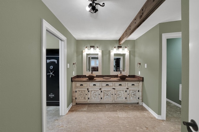 bathroom with vanity, baseboards, and beamed ceiling