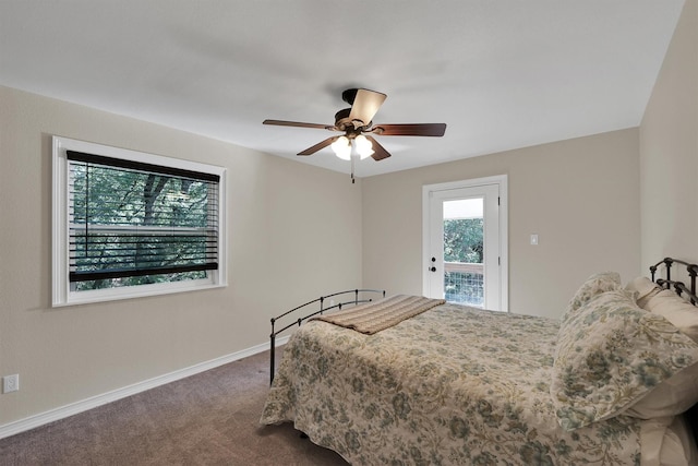 bedroom featuring dark carpet, baseboards, and a ceiling fan