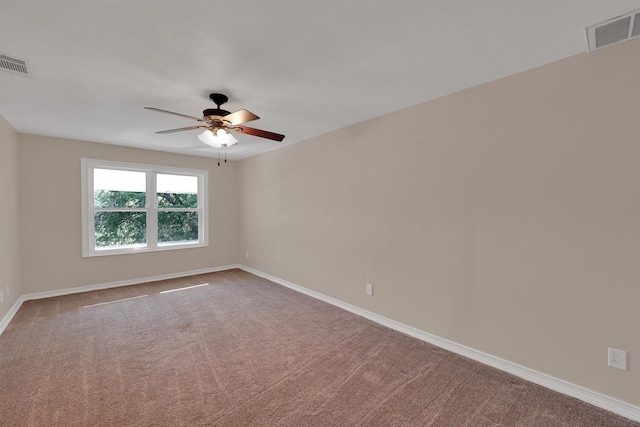 unfurnished room featuring a ceiling fan, carpet, and baseboards