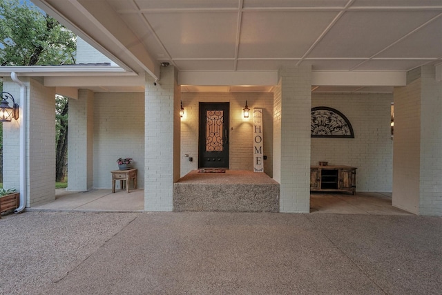 view of exterior entry with brick siding
