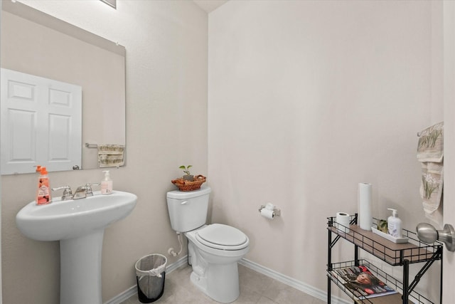 1145 Vernon Dr, Aubrey, TX 76227 - half bathroom featuring toilet, tile patterned floors, baseboards, and a sink