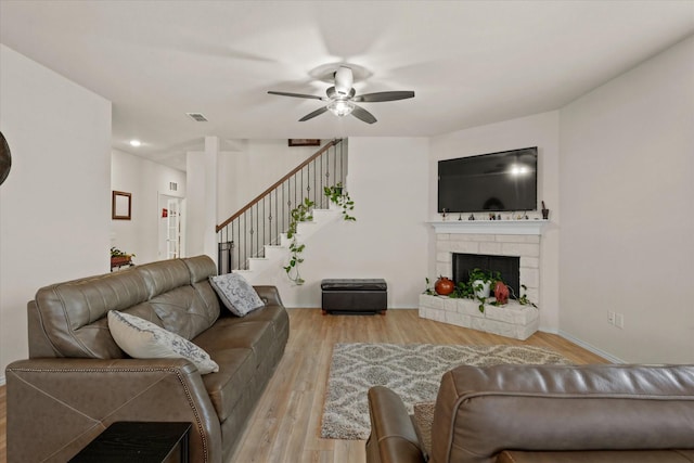 1145 Vernon Dr, Aubrey, TX 76227 - living room with a ceiling fan, wood finished floors, stairway, a fireplace with raised hearth, and baseboards