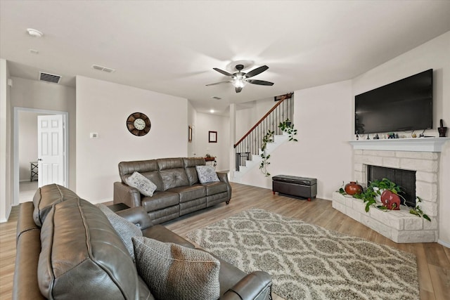 1145 Vernon Dr, Aubrey, TX 76227 - living room featuring ceiling fan, wood finished floors, stairway, and a stone fireplace