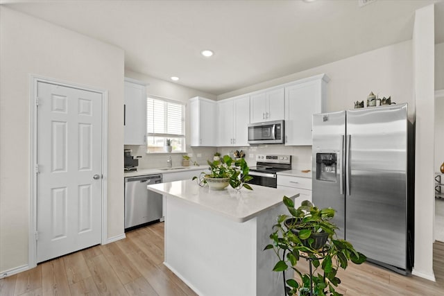1145 Vernon Dr, Aubrey, TX 76227 - kitchen with stainless steel appliances, white cabinetry, light wood-style flooring, light countertops, and recessed lighting