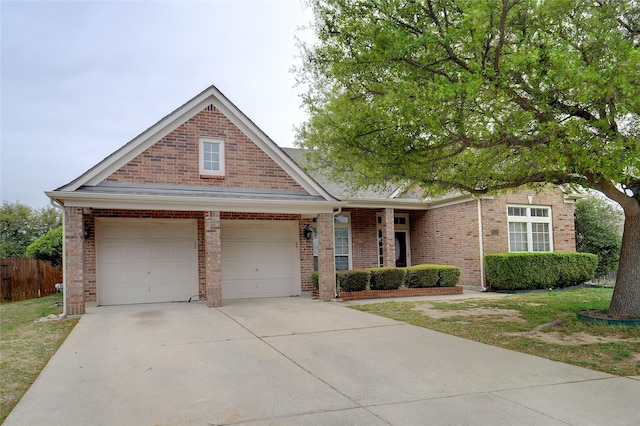 8652 Fernhill Dr, Fort Worth, TX 76123 - view of front of house featuring brick siding, driveway, fence, and a garage