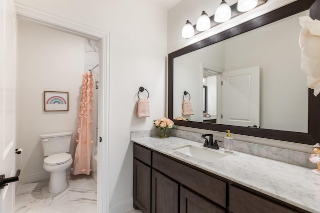 bathroom with marble finish flooring, vanity, toilet, and baseboards