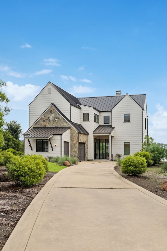 13736 Waterside Dr, Malakoff, TX 75148 - view of front facade with a standing seam roof, driveway, and stone siding
