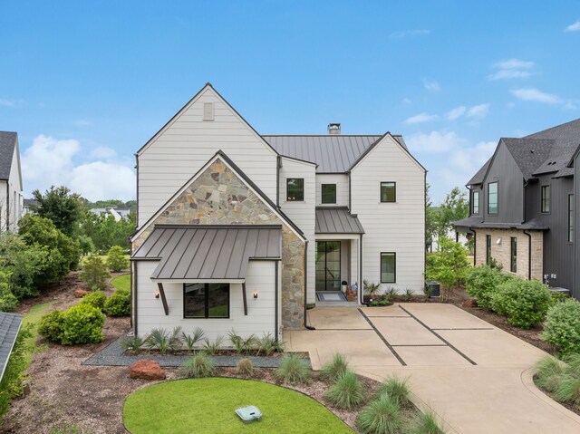 13736 Waterside Dr, Malakoff, TX 75148 - view of front of house featuring a standing seam roof, a patio area, and metal roof