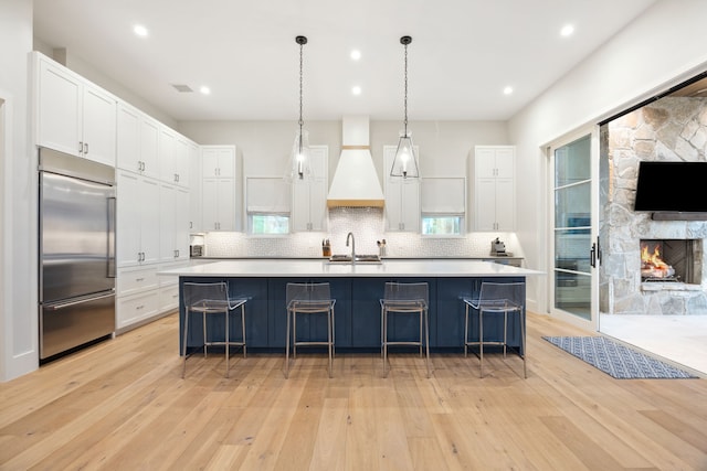 13736 Waterside Dr, Malakoff, TX 75148 - kitchen featuring stainless steel built in fridge, custom exhaust hood, light wood finished floors, light countertops, and recessed lighting