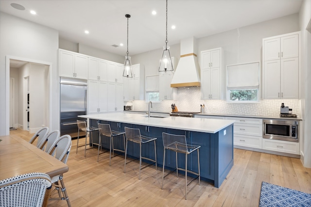 13736 Waterside Dr, Malakoff, TX 75148 - kitchen featuring built in appliances, custom exhaust hood, backsplash, white cabinets, and recessed lighting
