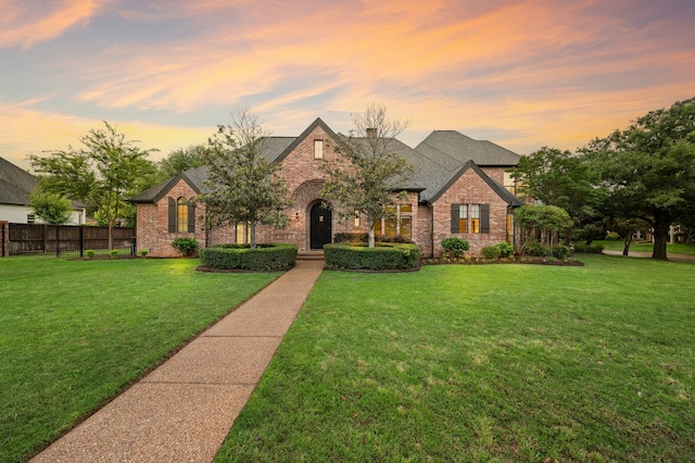 view of front of home with brick siding and roof with shingles