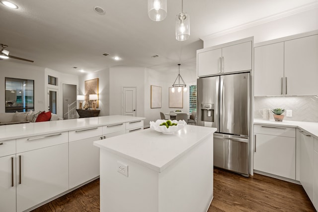kitchen with stainless steel fridge, recessed lighting, open floor plan, a kitchen island, and decorative backsplash