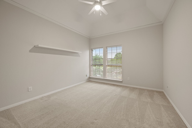 spare room featuring ceiling fan, light colored carpet, baseboards, ornamental molding, and lofted ceiling
