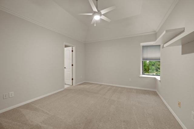 unfurnished room featuring a ceiling fan, light colored carpet, crown molding, baseboards, and vaulted ceiling