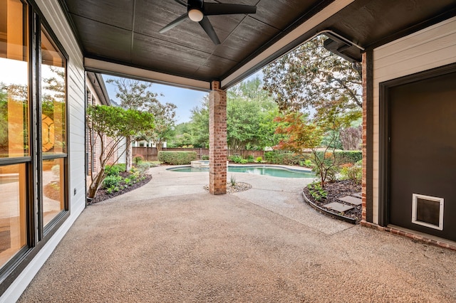 view of patio featuring ceiling fan, a fenced backyard, and a pool with connected hot tub