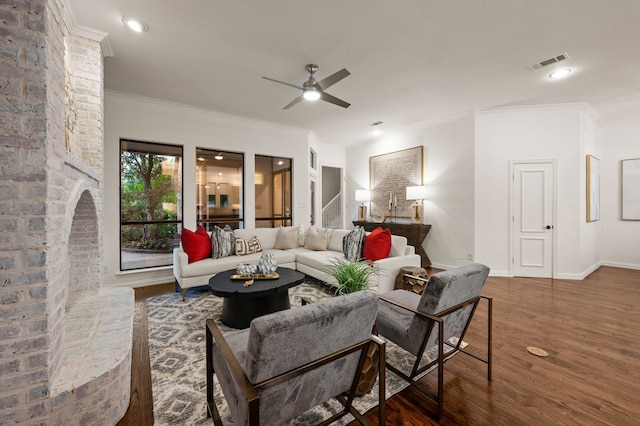 living room with wood finished floors, ceiling fan, ornamental molding, and baseboards