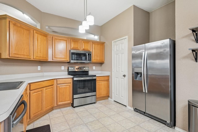 8833 Stirrup Way, Fort Worth, TX 76244 - kitchen featuring stainless steel appliances, light countertops, pendant lighting, and brown cabinetry