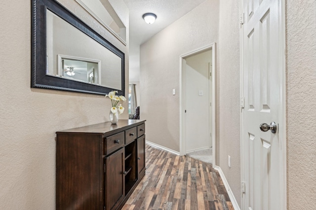 8833 Stirrup Way, Fort Worth, TX 76244 - hallway featuring wood finished floors, a textured wall, and baseboards