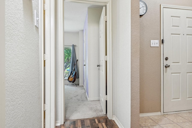 8833 Stirrup Way, Fort Worth, TX 76244 - hallway featuring a textured wall, wood finished floors, and baseboards