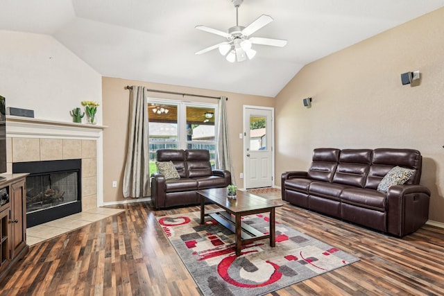8833 Stirrup Way, Fort Worth, TX 76244 - living room featuring vaulted ceiling, wood finished floors, ceiling fan, a tiled fireplace, and baseboards