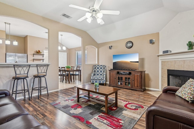 8833 Stirrup Way, Fort Worth, TX 76244 - living area featuring arched walkways, lofted ceiling, ceiling fan, wood finished floors, and baseboards