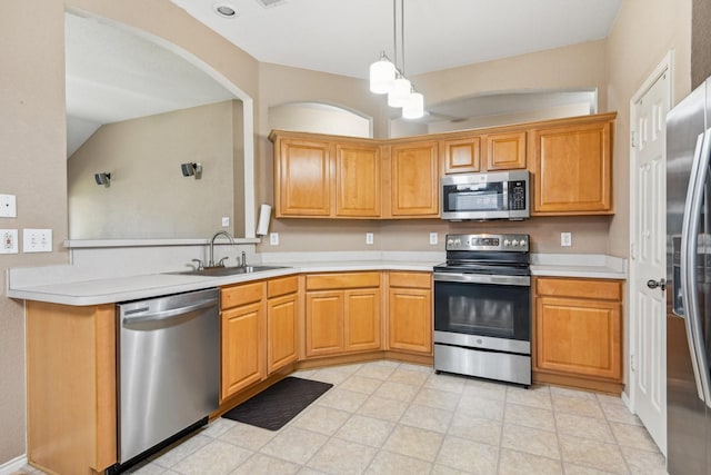 8833 Stirrup Way, Fort Worth, TX 76244 - kitchen with stainless steel appliances, a sink, light countertops, a peninsula, and pendant lighting