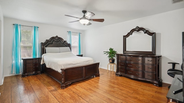 12712 Feathering Dr, Frisco, TX 75036 - bedroom featuring light wood-style floors, a ceiling fan, and baseboards