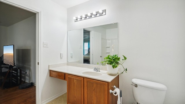 12712 Feathering Dr, Frisco, TX 75036 - bathroom with toilet, vanity, and baseboards