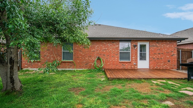 12712 Feathering Dr, Frisco, TX 75036 - rear view of house featuring a wooden deck, brick siding, and roof with shingles