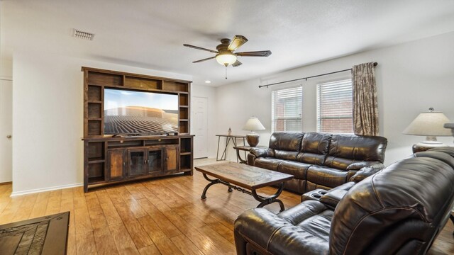 12712 Feathering Dr, Frisco, TX 75036 - living room featuring a ceiling fan, light wood-type flooring, and baseboards