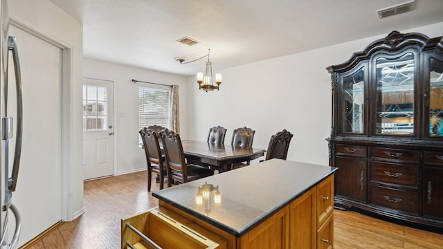12712 Feathering Dr, Frisco, TX 75036 - dining room with a chandelier and light wood-style floors