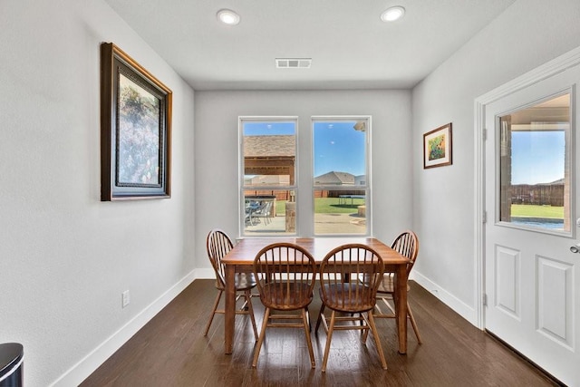dining space with dark wood finished floors, baseboards, and recessed lighting