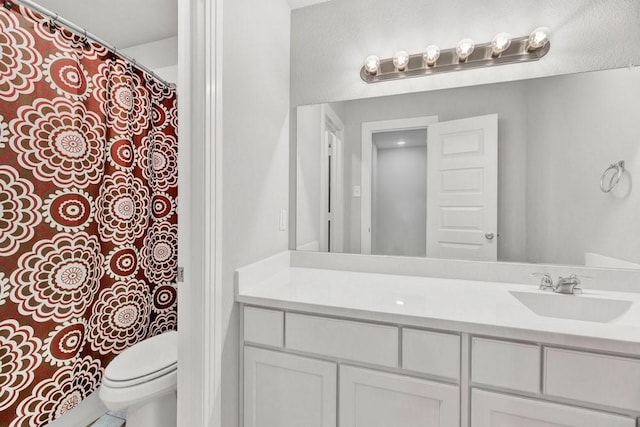 full bathroom featuring toilet and vanity