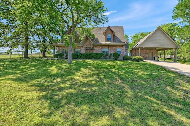 376 Tananger Springs Dr, Denison, TX 75021 - new england style home with a front lawn, a carport, brick siding, and driveway