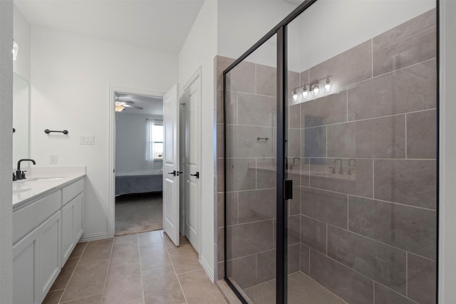 1420 Escondido Dr, Fort Worth, TX 76052 - ensuite bathroom with a stall shower, tile patterned flooring, double vanity, ceiling fan, and baseboards