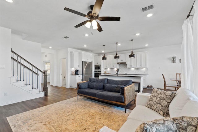 1420 Escondido Dr, Fort Worth, TX 76052 - living room with wood finished floors, ceiling fan, stairway, baseboards, and recessed lighting