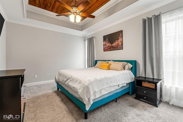 carpeted bedroom with a raised ceiling, ornamental molding, wooden ceiling, baseboards, and a ceiling fan
