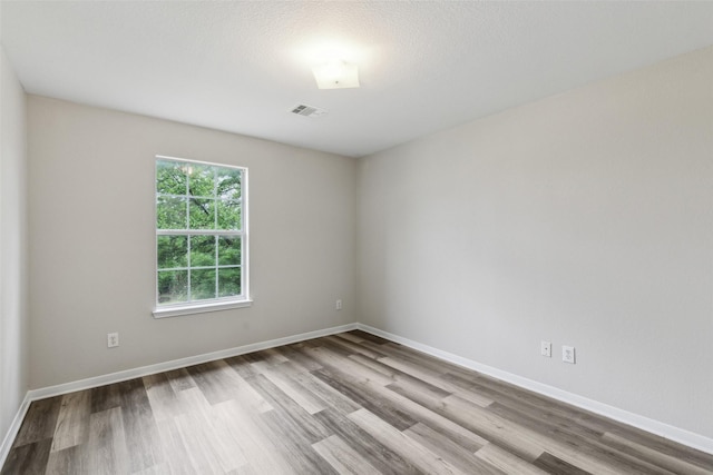 empty room with wood finished floors and baseboards
