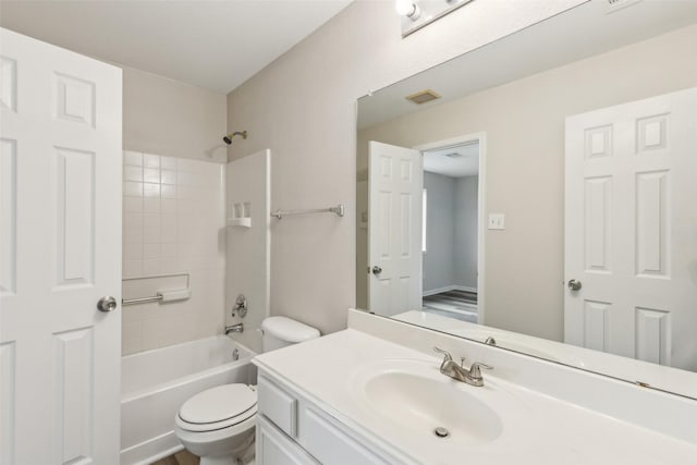 bathroom featuring toilet, vanity, and washtub / shower combination