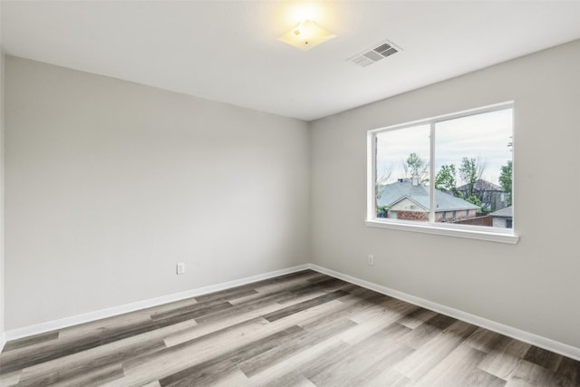 unfurnished room with wood finished floors and baseboards