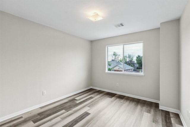 unfurnished room with wood finished floors and baseboards